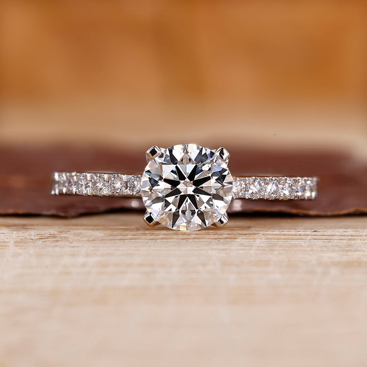 Round cut engagement ring with pave setting.
