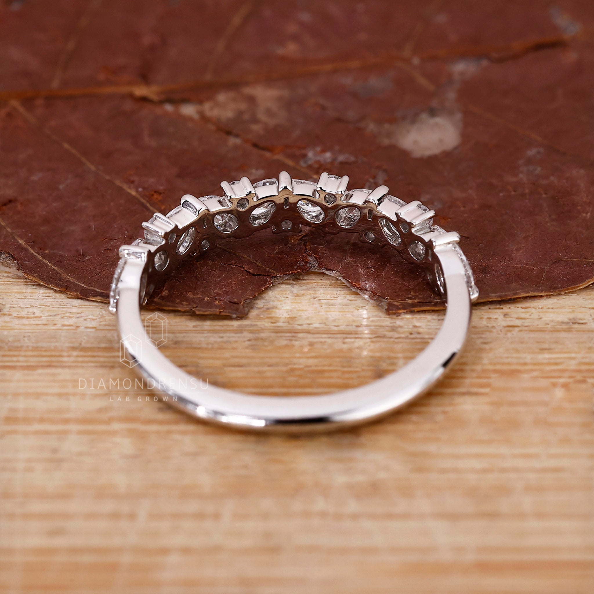 Shared prong setting in a pear and round pattern.
