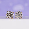 4 carat diamond stud earrings in yellow gold.