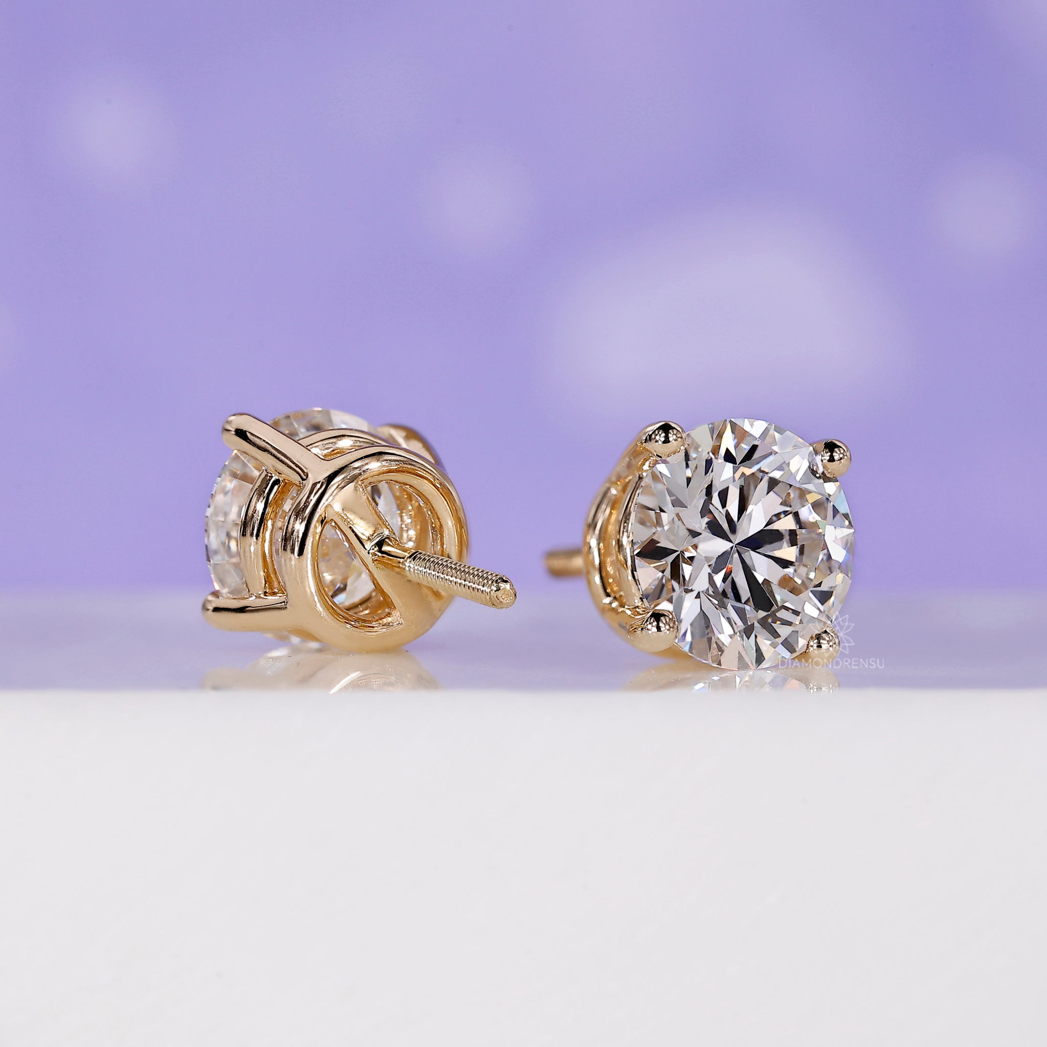 Large round diamond stud earrings.