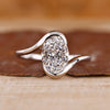 Solitaire engagement ring with oval diamond center.

