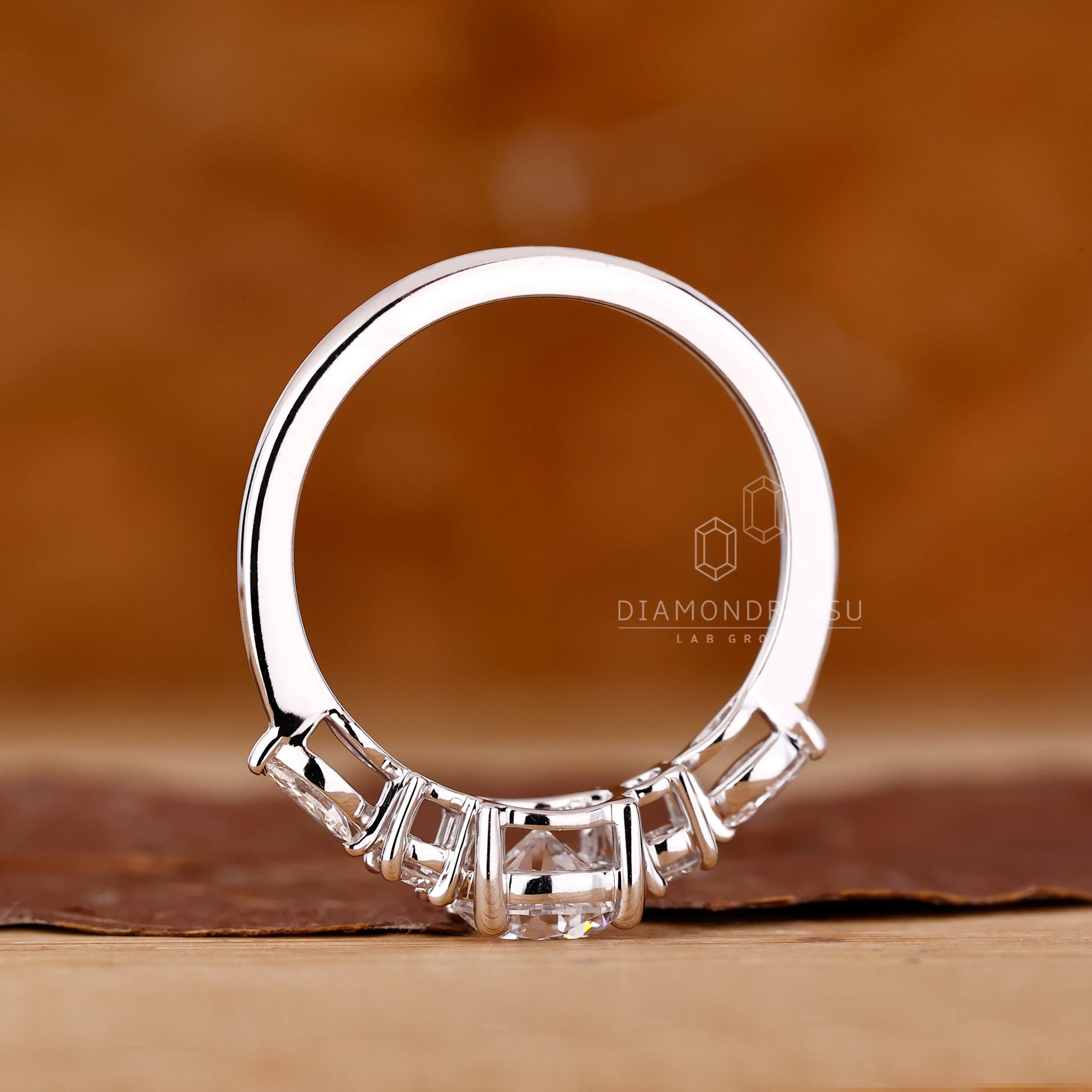 Custom engagement ring with tapered band and prong setting.
