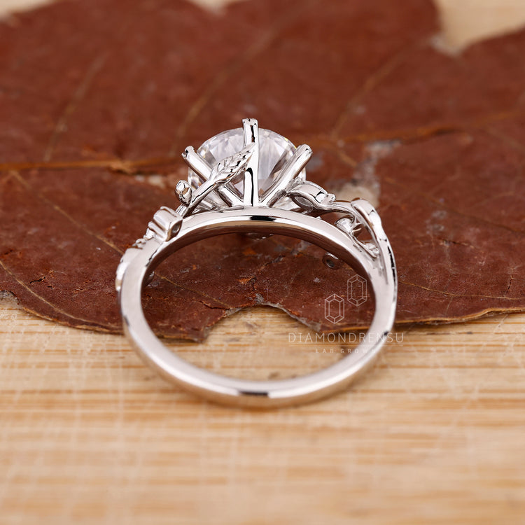 Nature inspired engagement ring with marquise side stones and lab grown diamonds.
