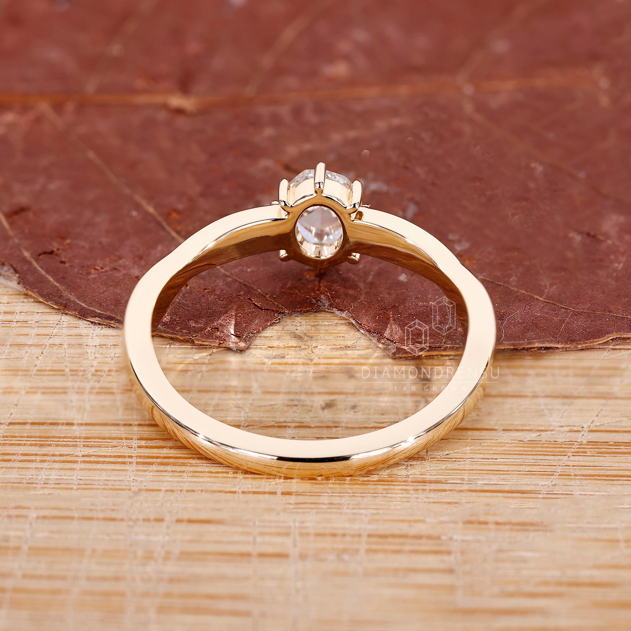 Yellow gold engagement ring with oval cut diamond