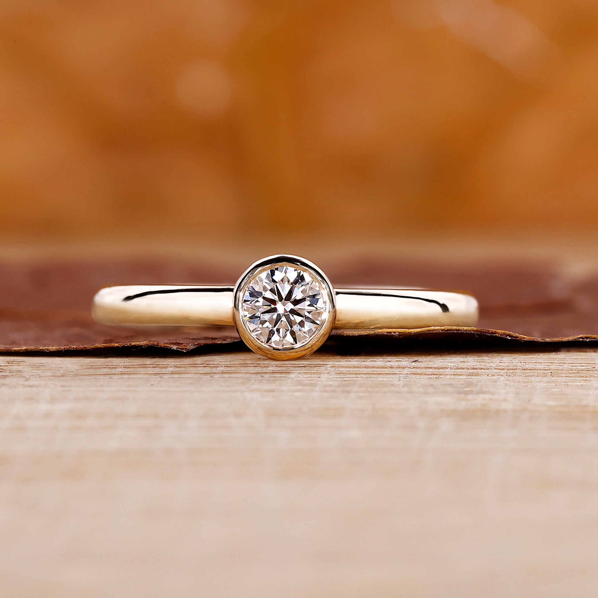 Bezel Set Diamond Ring with round cut diamond center.
