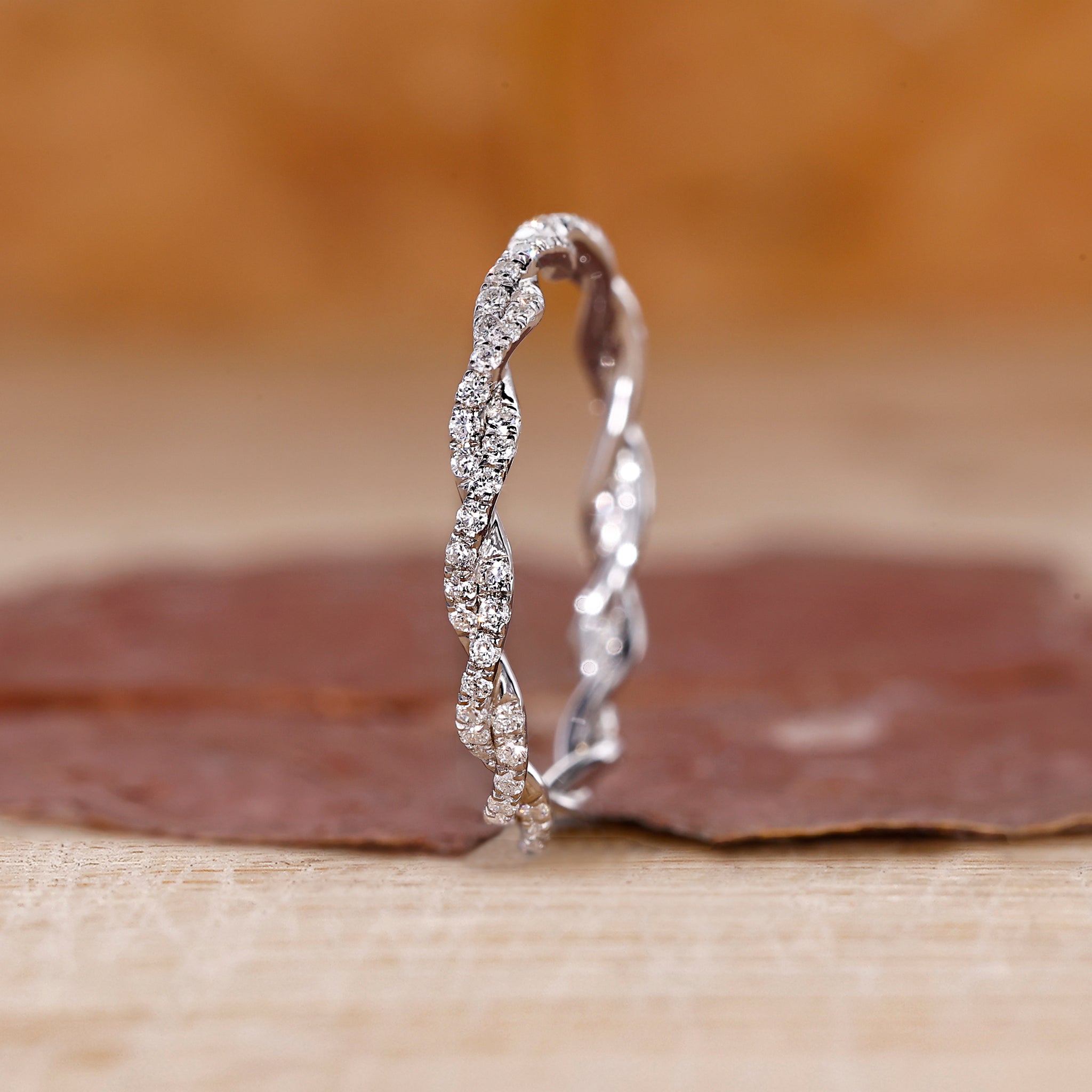 Twisted wedding band with round diamonds set in white gold.