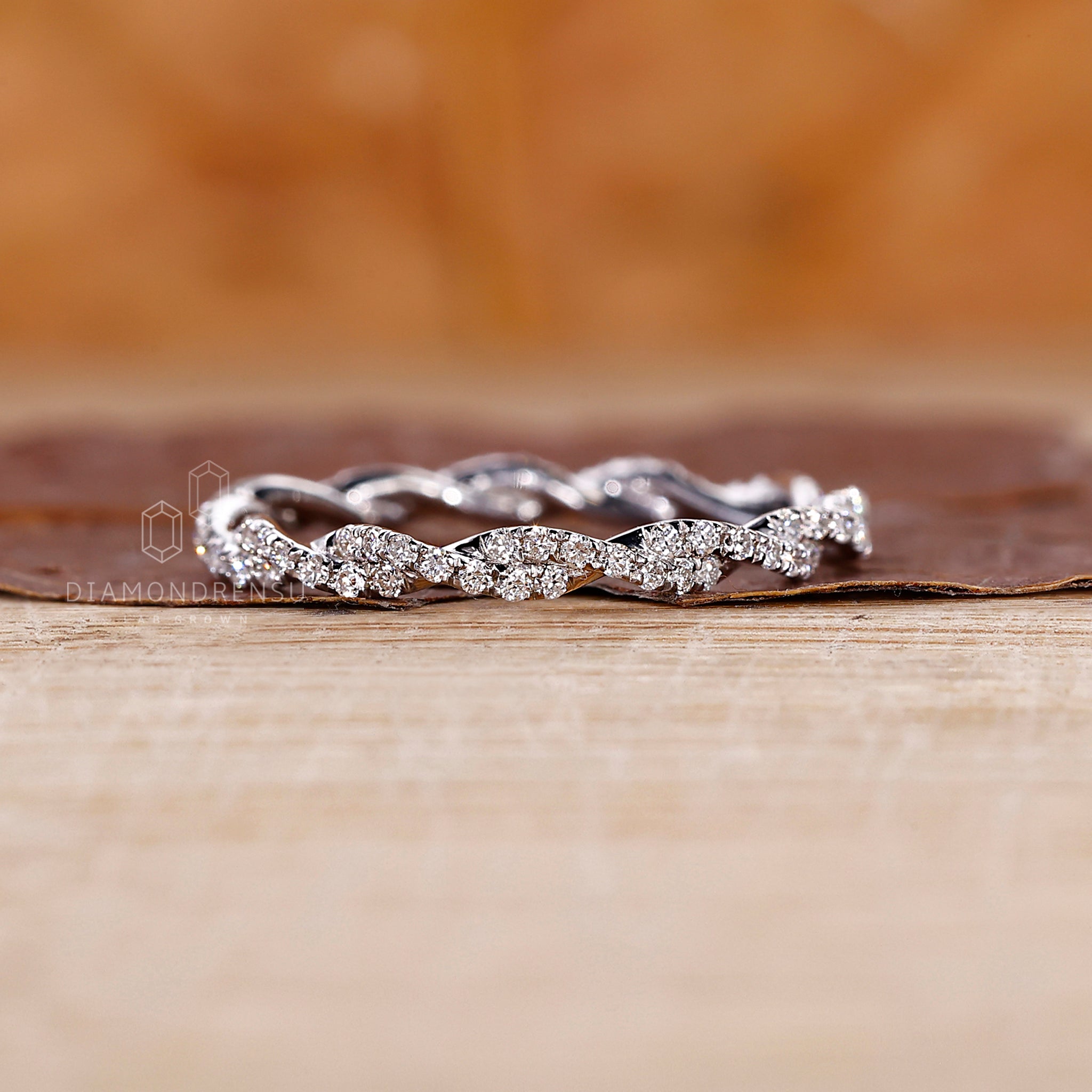 Handmade band with a white gold base and twisted diamond detail.