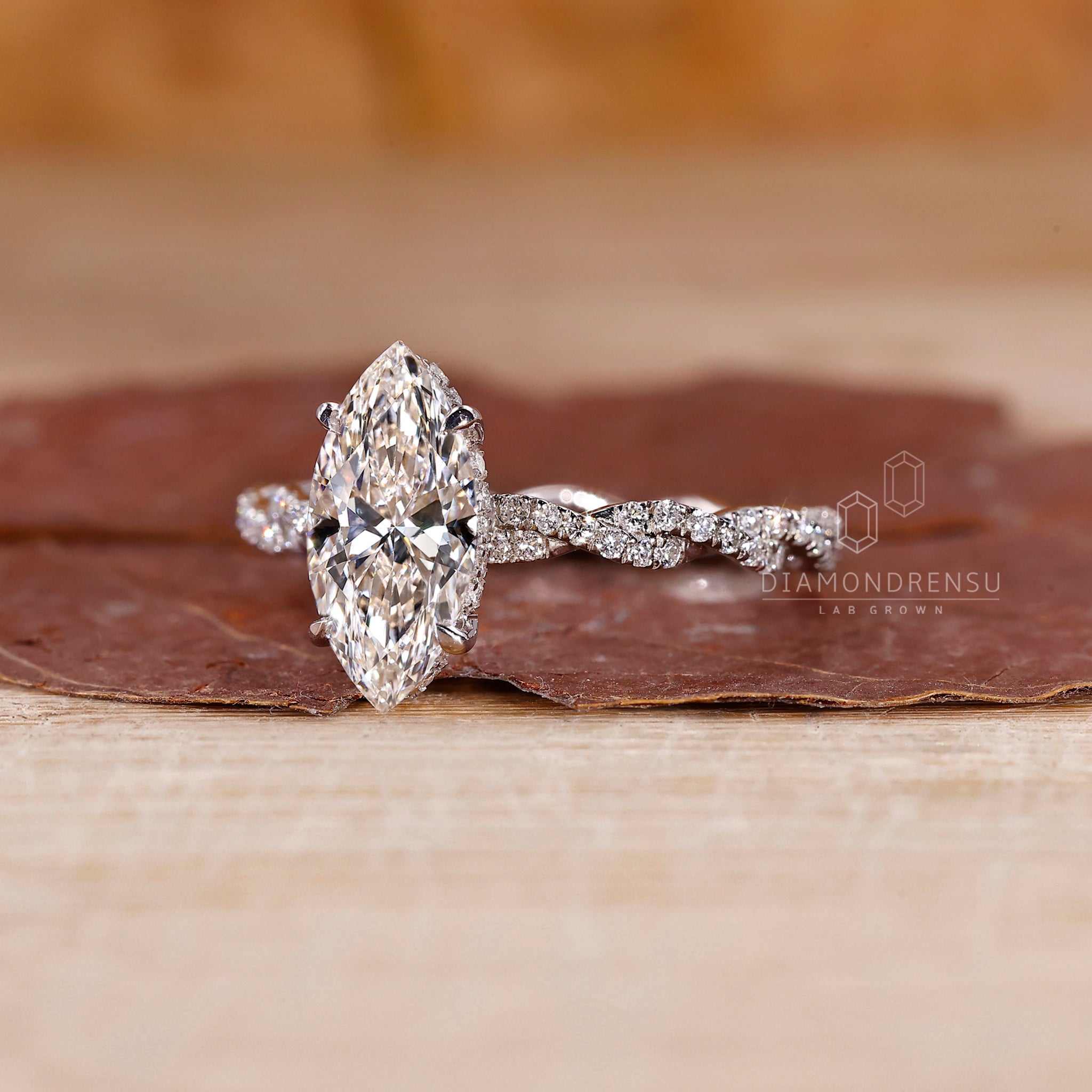 Twist engagement ring made with marquise diamond center.

