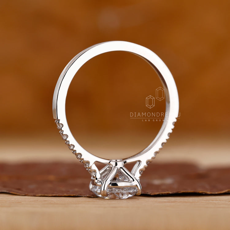 Round cut diamond ring with prong and pave details