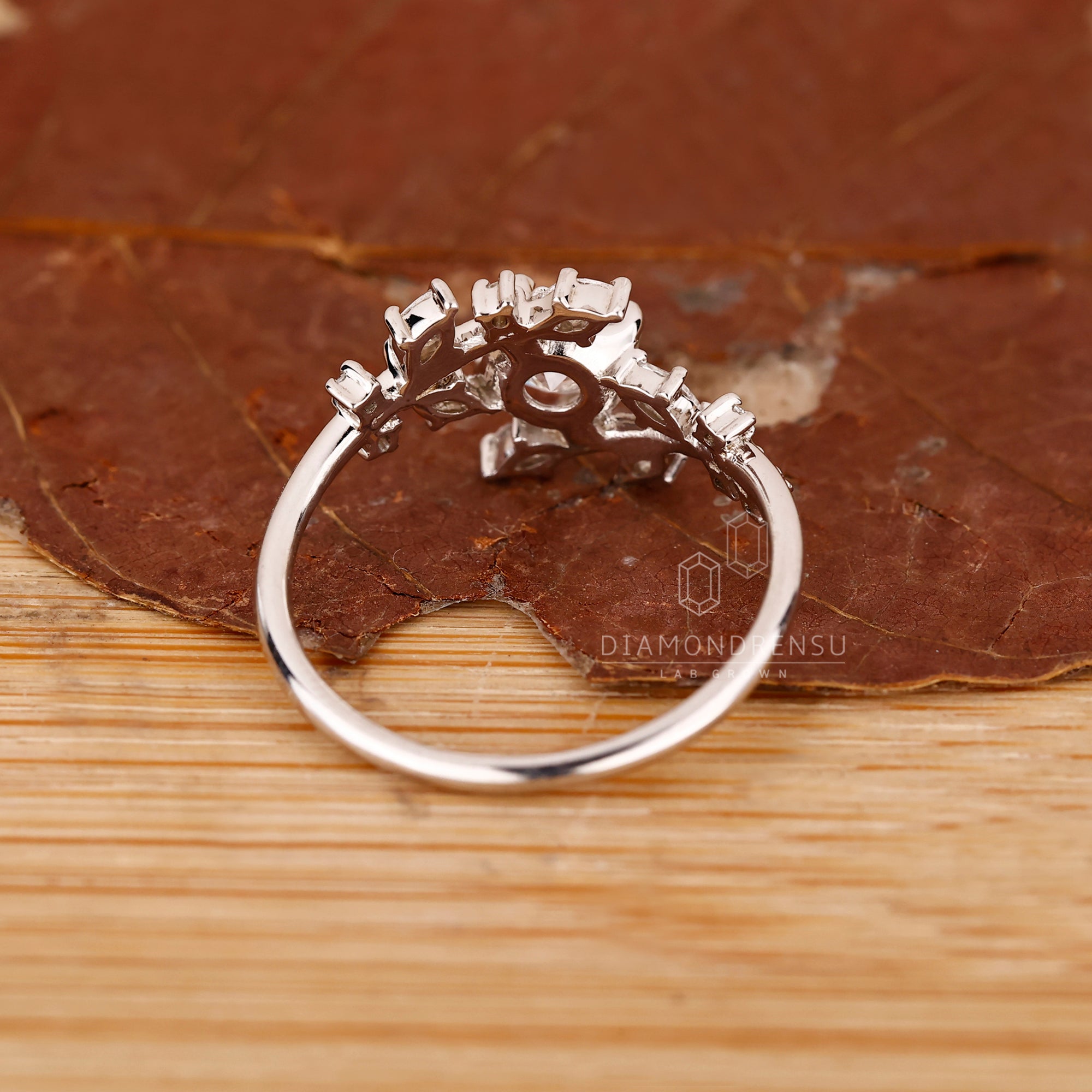 White gold ring with round and marquise layout.
