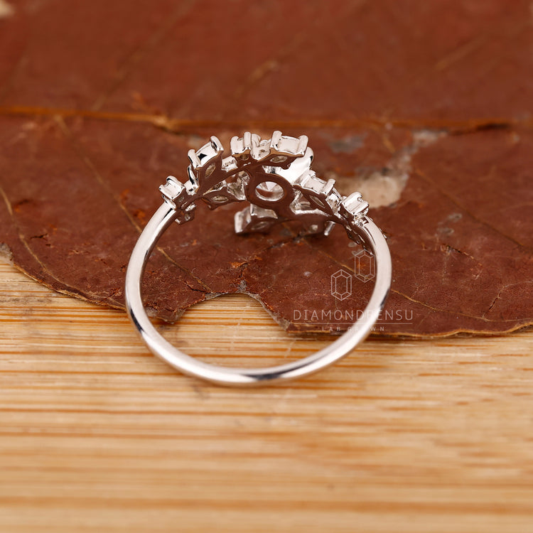 White gold ring with round and marquise layout.
