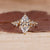 Marquise diamond ring with round cluster style design.
