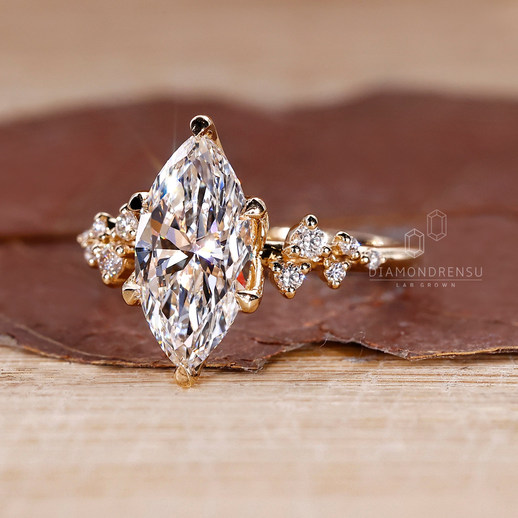 Tulip ring with marquise diamond side stone.
