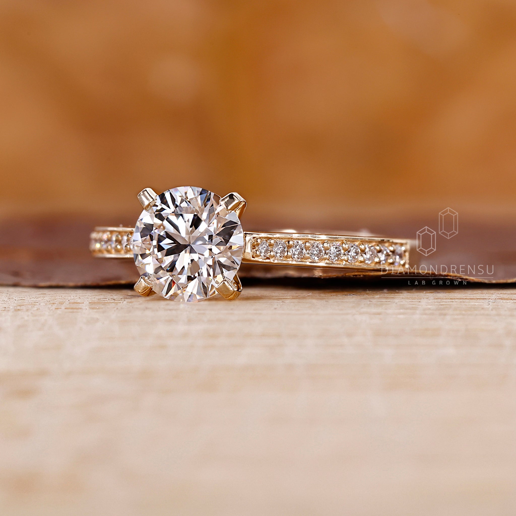 Round diamond side stone in custom engagement ring detail.
