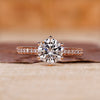 Round cut diamond ring set in a classic 6 prong ring setting on rose gold.

