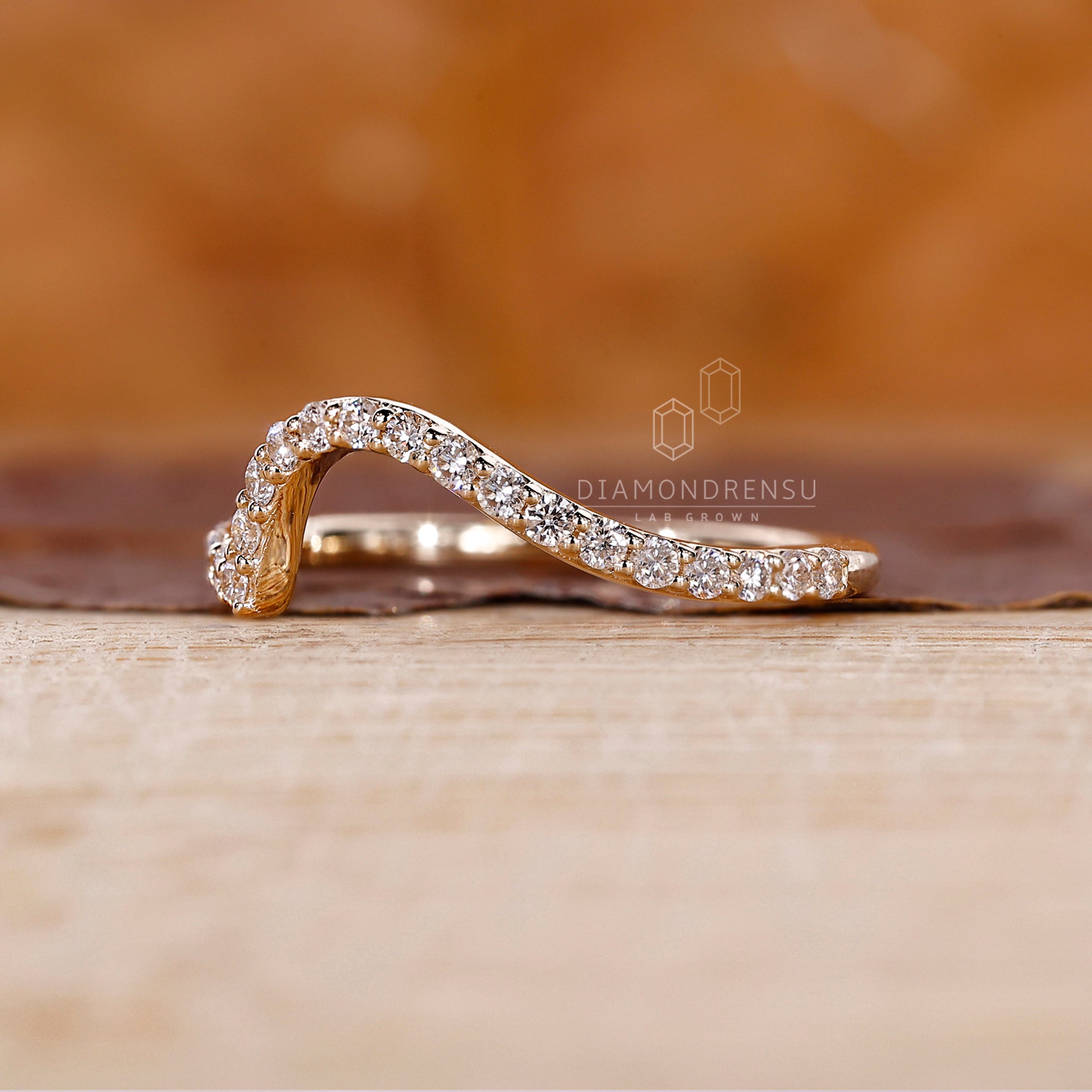 Yellow gold diamond band with round cut lab grown stones.