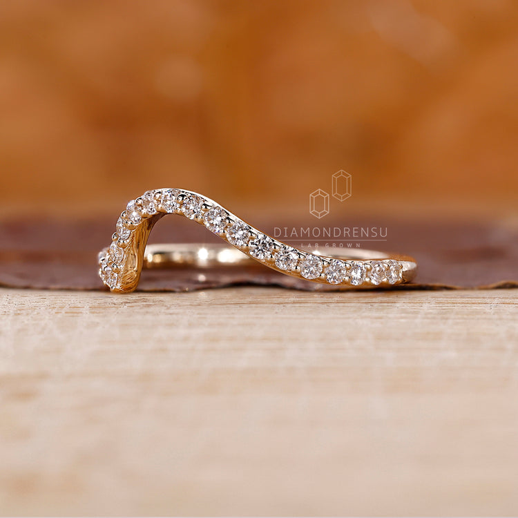 Yellow gold diamond band with round cut lab grown stones.