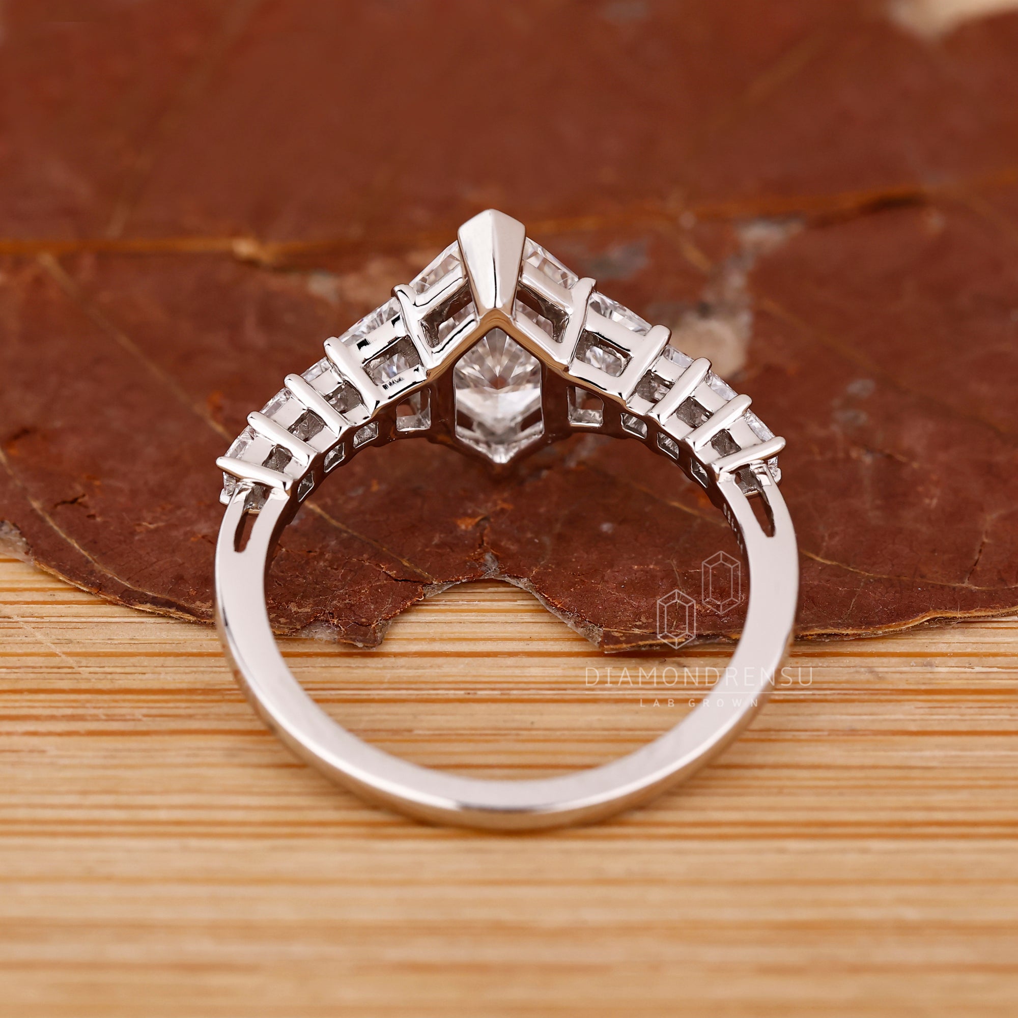 Custom engagement ring with V prong and pave details.
