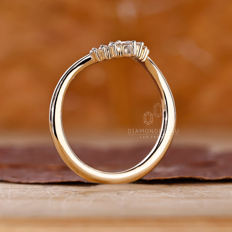 Custom diamond band with pear and round diamonds in yellow gold.