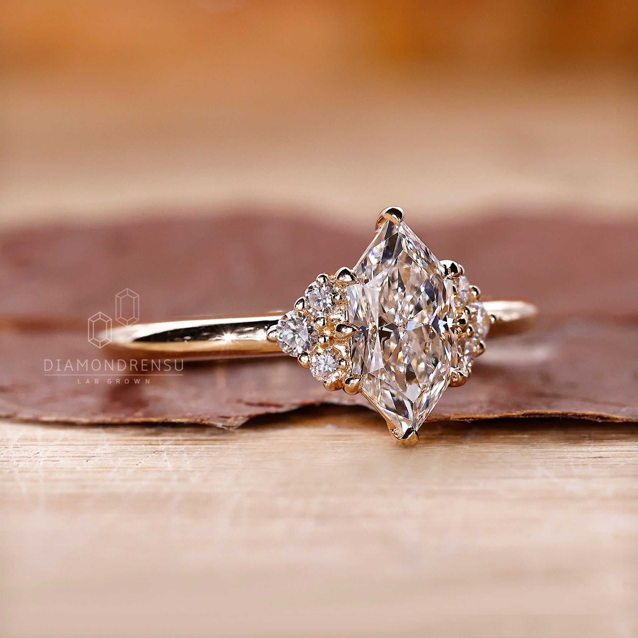 Marquise Cut diamond ring with round diamond side stone.
