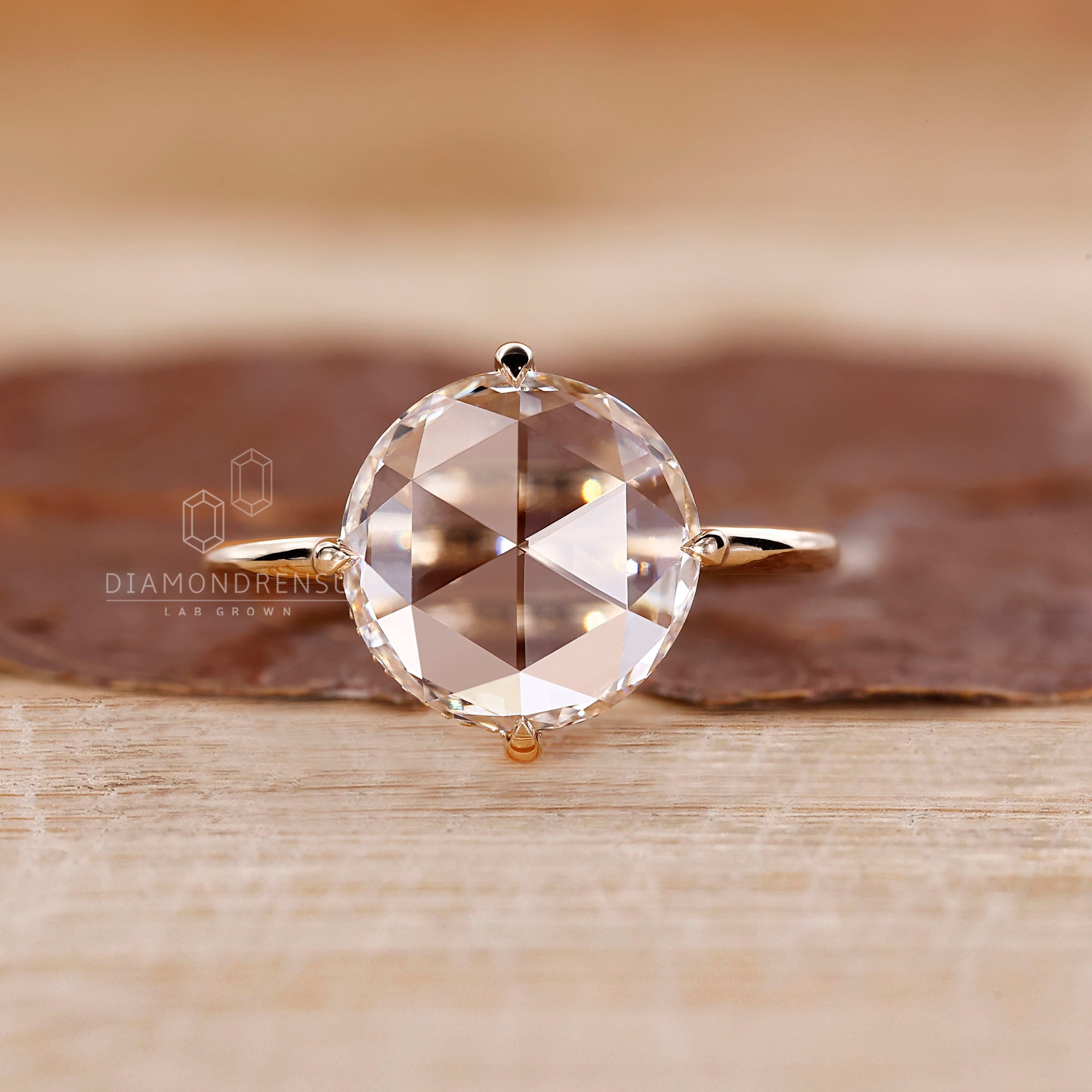 Round cut hidden halo set in yellow gold band.
