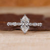 Marquise diamond ring with shared prong setting.
