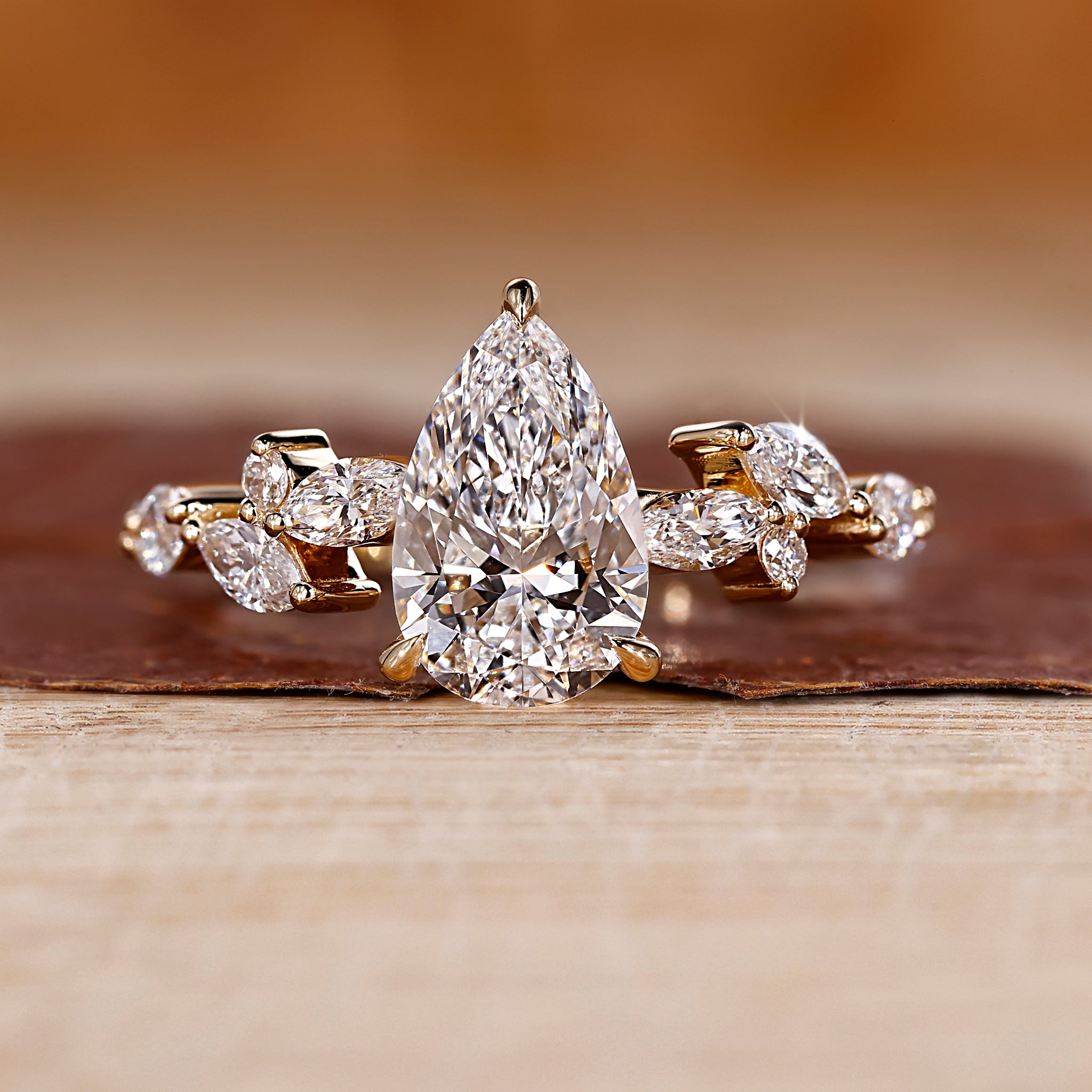 Pear shaped engagement ring in yellow gold.