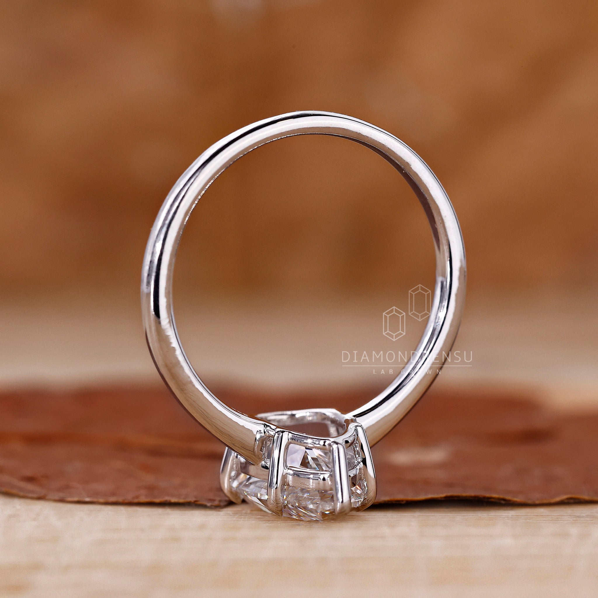 Handmade jewellery ring featuring pear shaped diamond and white gold band.