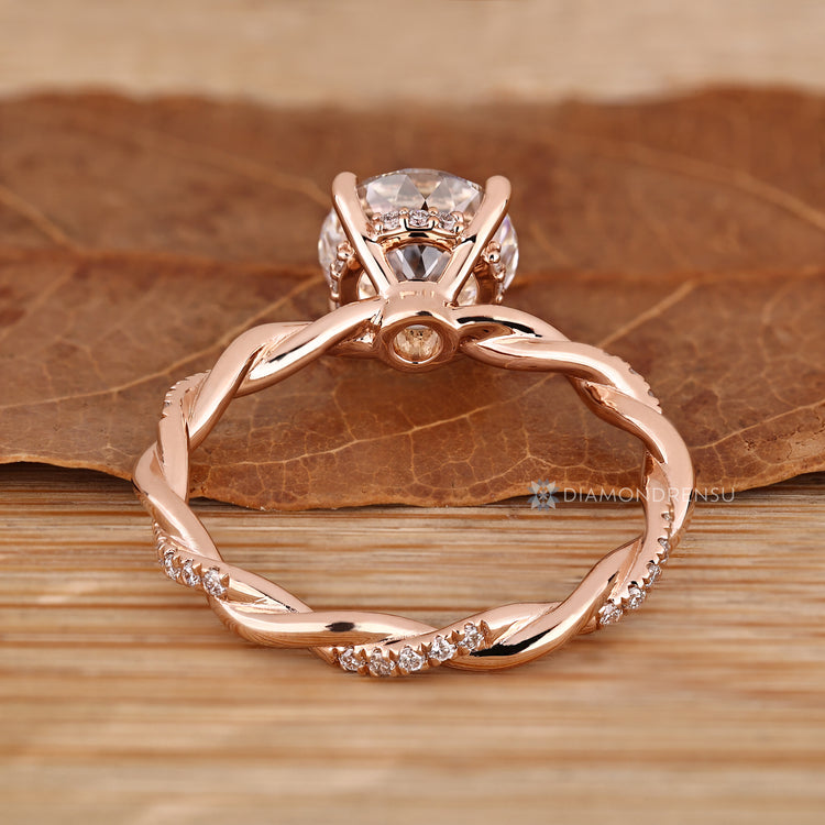 Twisted shank engagement ring with pavé diamond details.