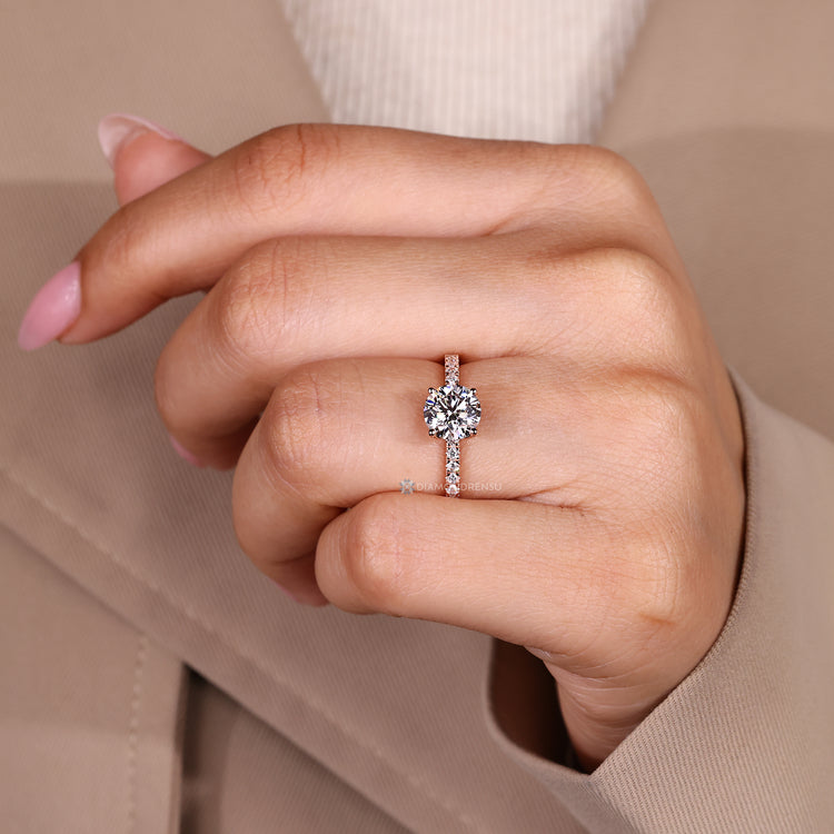 Round cut ring with pavé style and four prongs.