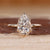 Pear cut lab grown diamond ring with side halo.