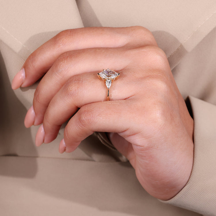 Lab grown ring with pear side stones and prong setting.