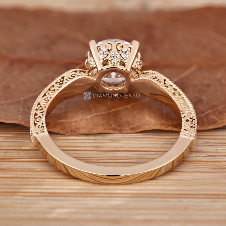 Handmade round diamond ring with hidden diamond accents.