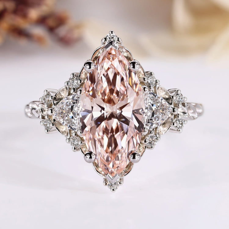 Marquise engagement ring with pink centre diamond and side stones.