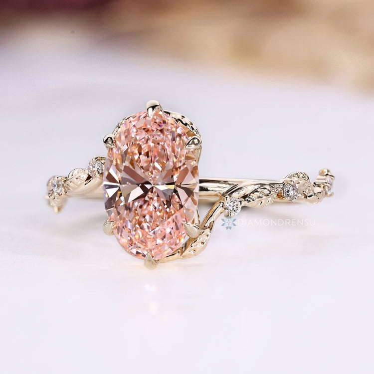IGI certified oval cut ring with pink centre diamond.