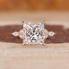 Princess cut engagement ring with marquise side stones.