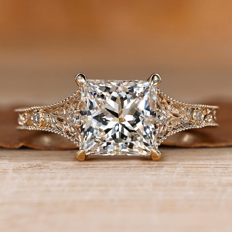 Princess cut engagement ring with round side stones.