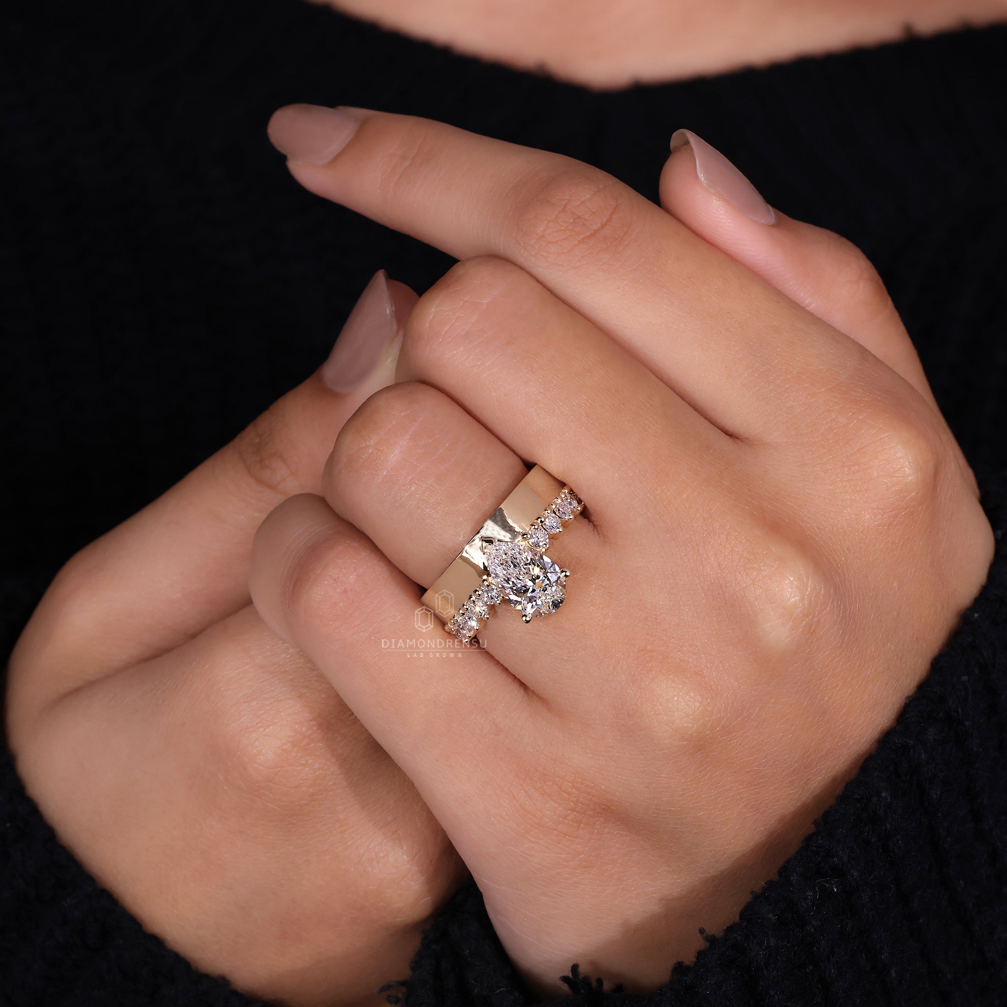 Yellow gold ring with pear shaped ring detail
