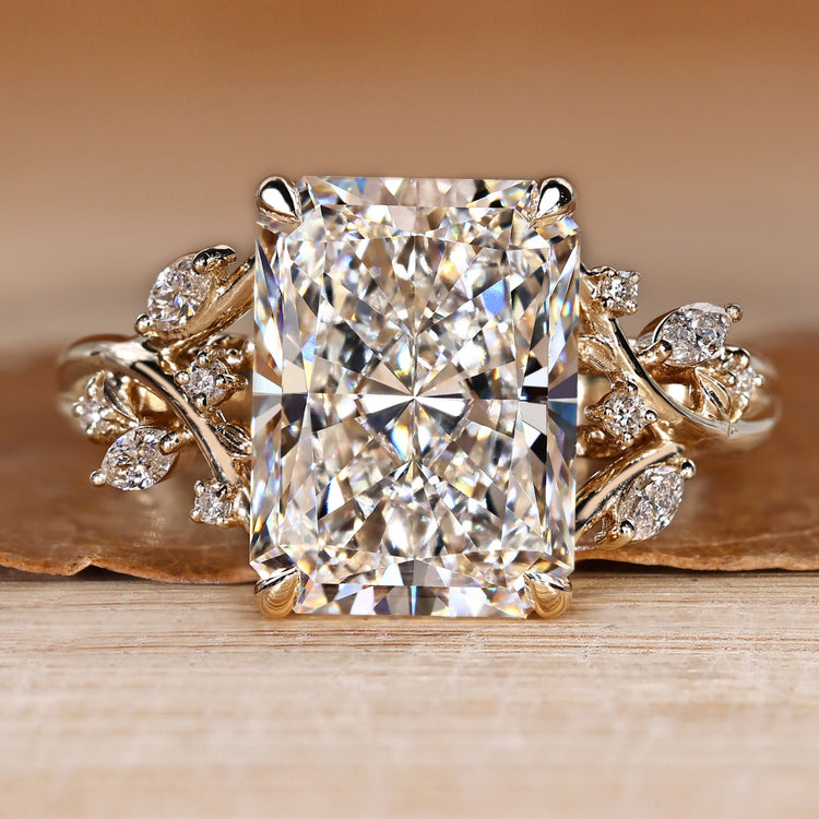 Radiant cut diamond ring with marquise and round side stones.