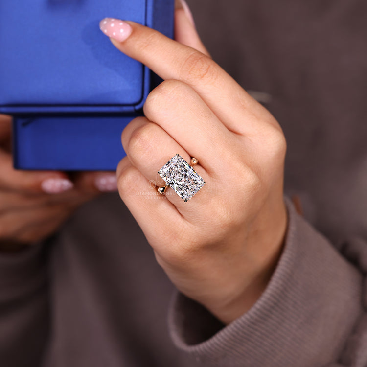 Handmade radiant cut ring with round pave accents.
