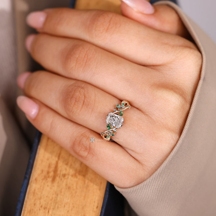 Nature inspired radiant cut engagement ring with emeralds.
