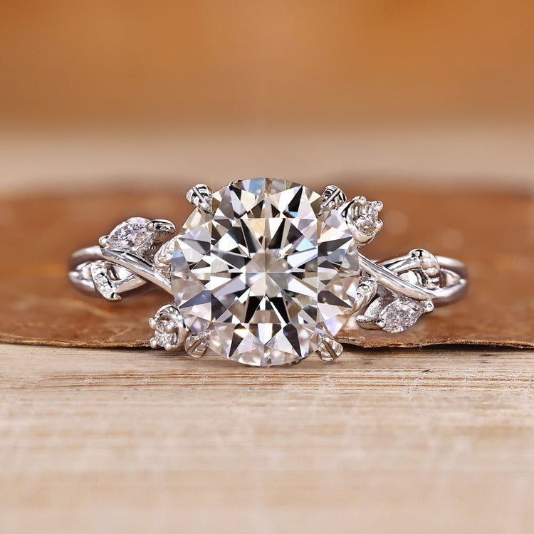 Round cut diamond ring with marquise and round side stones.