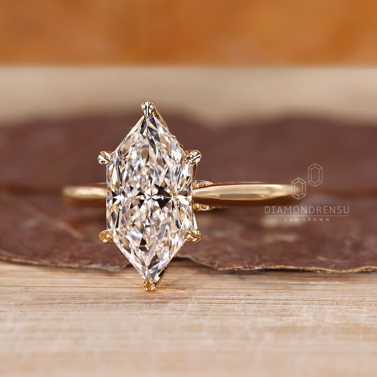 Marquise cut engagement ring with tapered shank and halo.