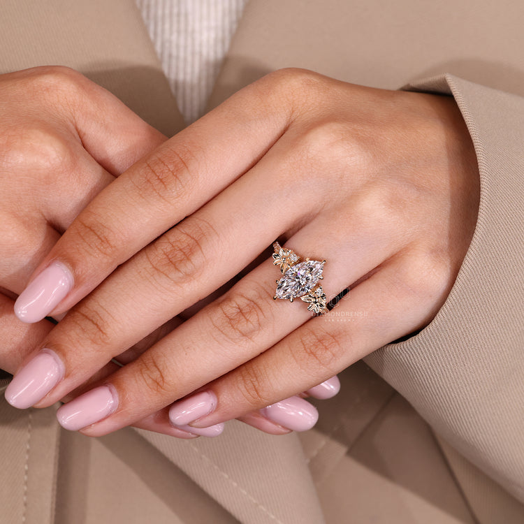 Marquise cut ring with pave band and detailing.