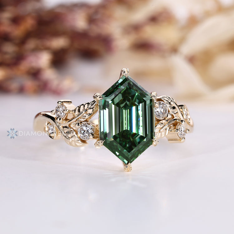 Green centre diamond ring with round side stones.