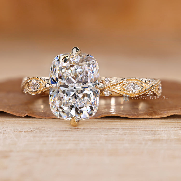 Cushion diamond ring with round and marquise side stones.