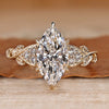 Marquise cut diamond ring with round side stones.