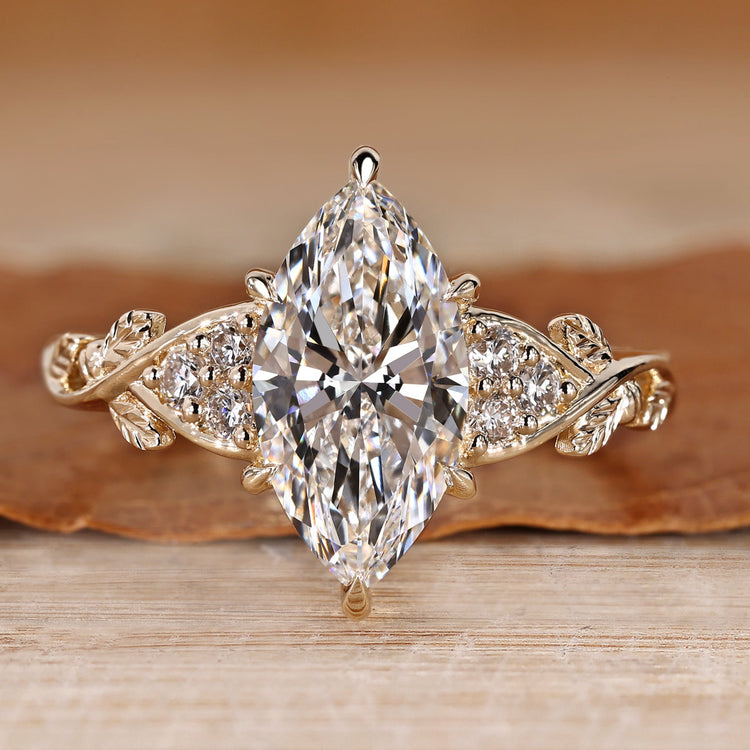 Marquise cut diamond ring with round side stones.