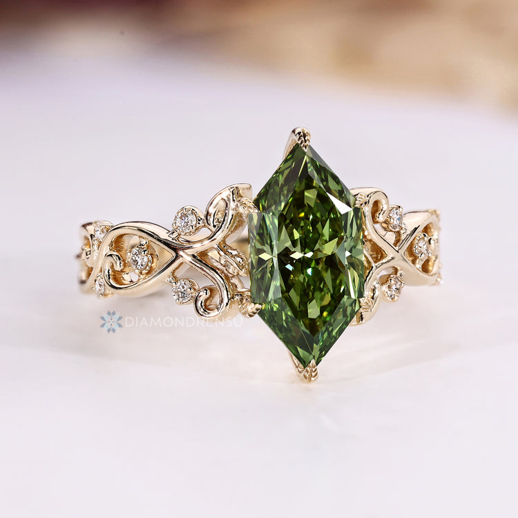 Nature inspired ring with green diamond and round side stones.
