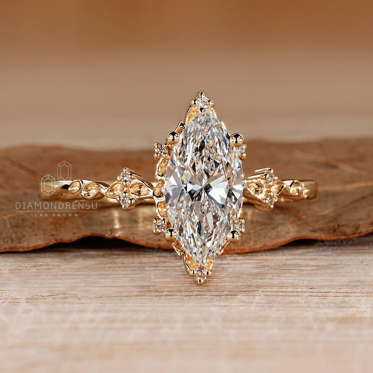 Handmade marquise diamond ring with nature inspired style details.